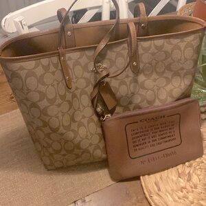 Large coach with makeup bag.